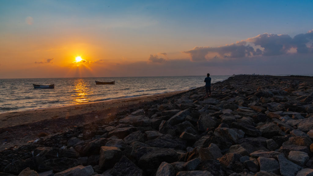 A tourist enjoying the beautiful sunset from the Dhanushkodi beach in Tamilnadu.
